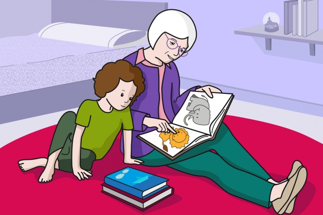 En la escena, se observa a una persona mayor leyendo un cuento a una niña, sentadas en la alfombra.